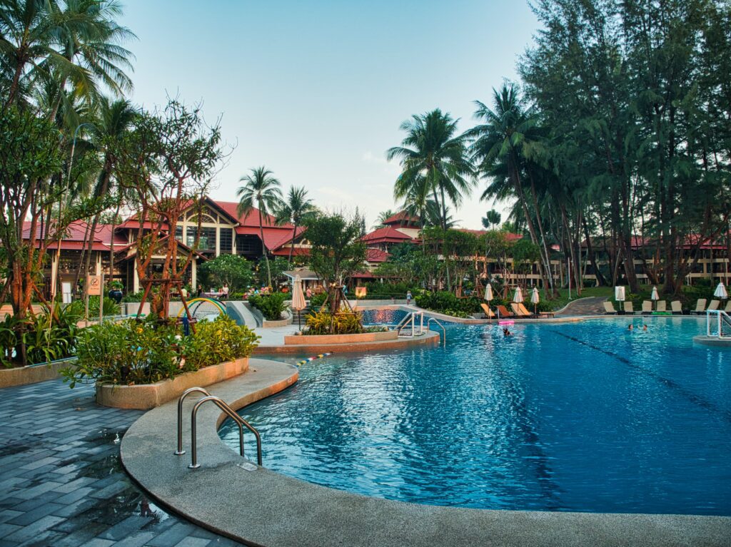 A resort with a pool, clear skies, and warm weather. Family Vacation.